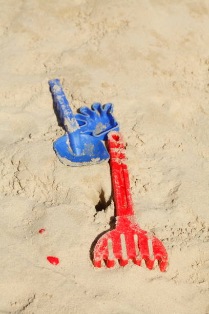 istock Rake, plastic toys in a sandbox 696949584