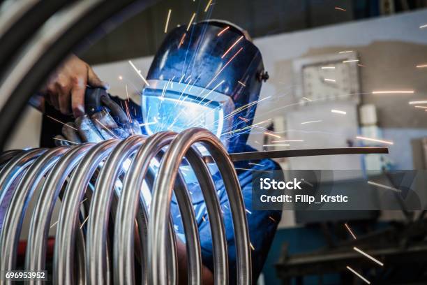 Worker Is Welding Metal Tubes Stock Photo - Download Image Now - Metal, Welding, Metalwork