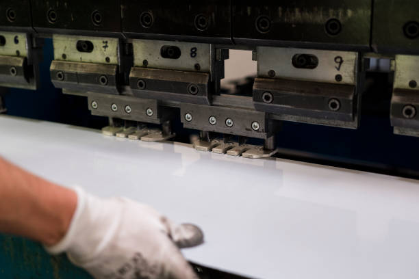 istock Worker bending a sheet of aluminium. 696954728