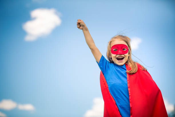istock Funny little girl playing power super hero. 696963202