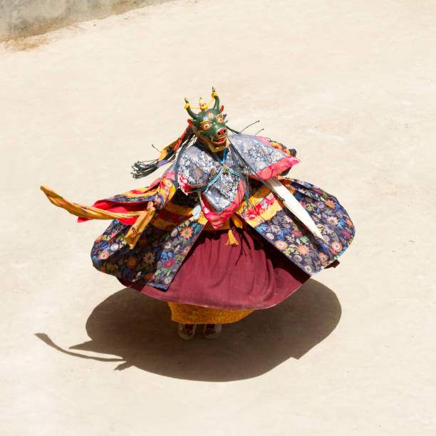 Unidentified monk performs a religious masked and costumed mystery dance of Tibetan Buddhism during the Cham Dance Festival Lamayuru, India - June 17, 2012: Unidentified monk performs a religious masked and costumed mystery dance of Tibetan Buddhism during the Cham Dance Festival in Lamayuru monastery, India. cham mask stock pictures, royalty-free photos & images