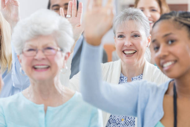 istock Woman raises hand during seminar 696977706