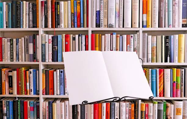 Music stand with open white sheets in front of book shelves Music stand with open white sheets in front of book shelves büro stock pictures, royalty-free photos & images