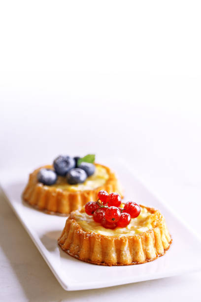 istock Tarts with berries (blueberry and red currant). Freshly baked dessert on a white background. 696982256