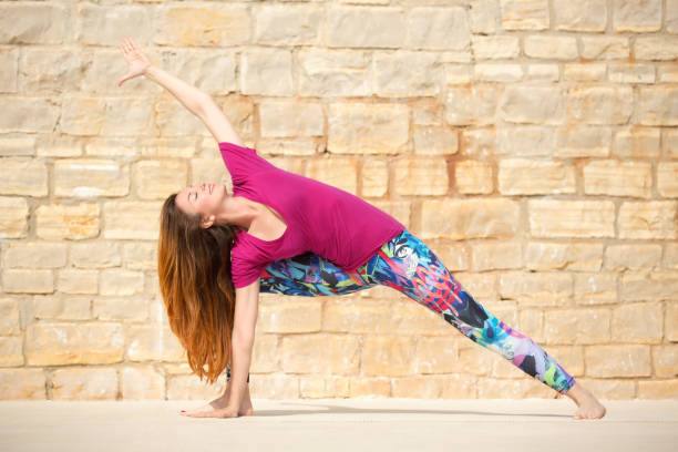 istock Woman  doing yoga exercise. Extended Side Angle pose, Utthita Parsvakonasana 696985202