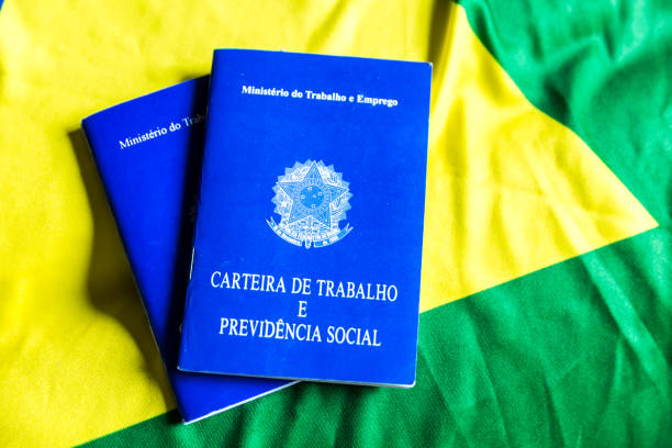 istock Brazilian work document and social security document (Portuguese: Carteira de Trabalho) on brazilian flag 696985658