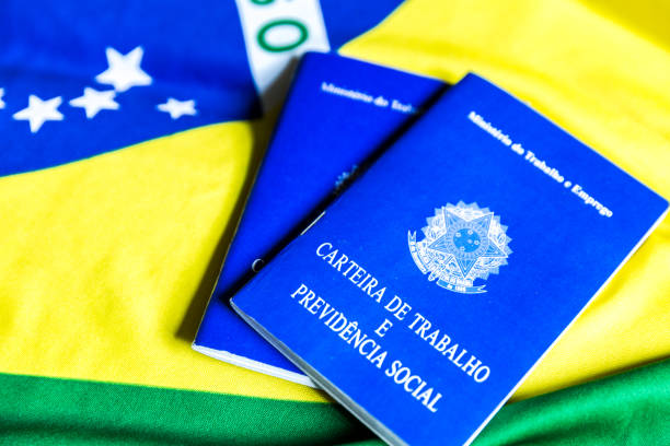 istock Brazilian work document and social security document (Portuguese: Carteira de Trabalho) on brazilian flag 696985660