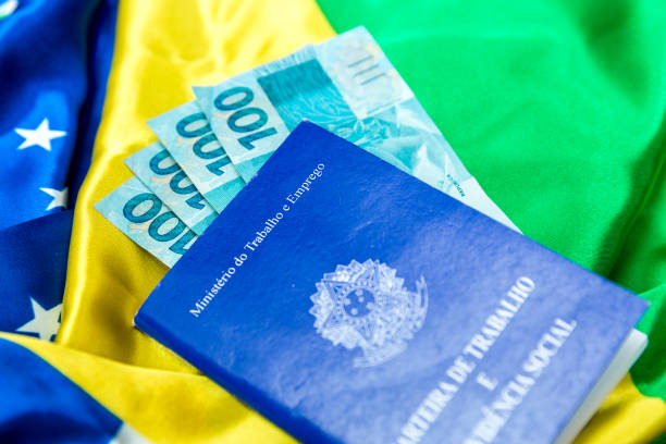 istock Brazilian work document and social security document (Portuguese: Carteira de Trabalho) on brazilian flag 696985882