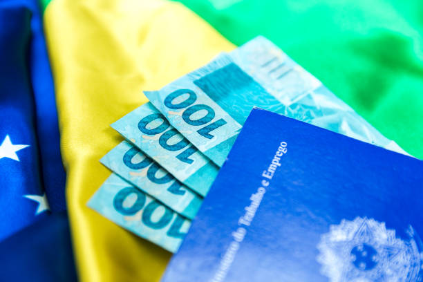 istock Brazilian work document and social security document (Portuguese: Carteira de Trabalho) on brazilian flag 696985890