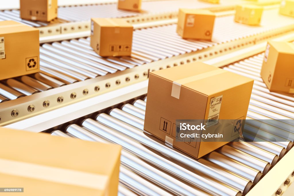 Packages delivery, packaging service and parcels transportation system concept Cardboard boxes on conveyor belt in warehouse Freight Transportation Stock Photo