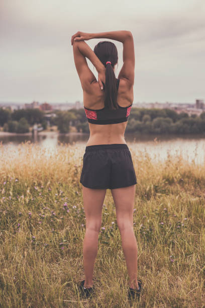 istock Sporty woman exercising 697008002