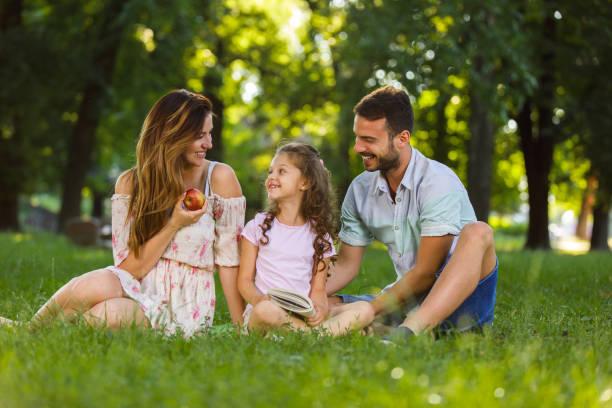istock Young happy family enjoying spending time in the park 697016476