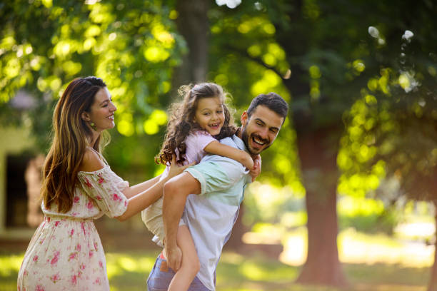 istock Happy family having fun in the park 697016892