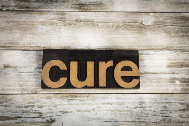istock Cure Letterpress Word on Wooden Background 697020412