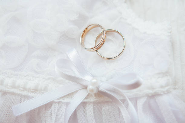 istock gold wedding rings on a pillow 697020548