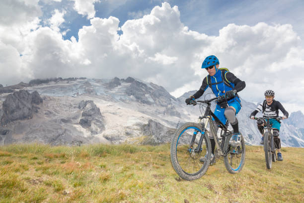 istock Mountainbiking in front of Mt. Marmolada, Dolomites, Italy 697023786