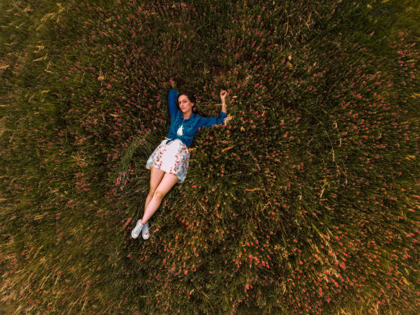 istock Woman in the flower field during sunset 697026716