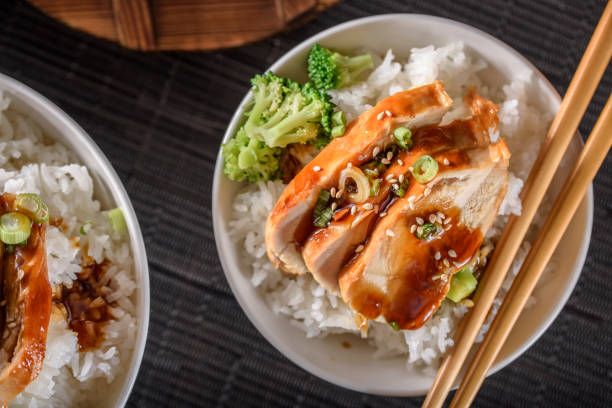 istock Grilled Chicken Breast with Teriyaki Sauce over Steamed Rice 697028148