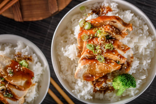 istock Grilled Chicken Breast with Teriyaki Sauce over Steamed Rice 697028242