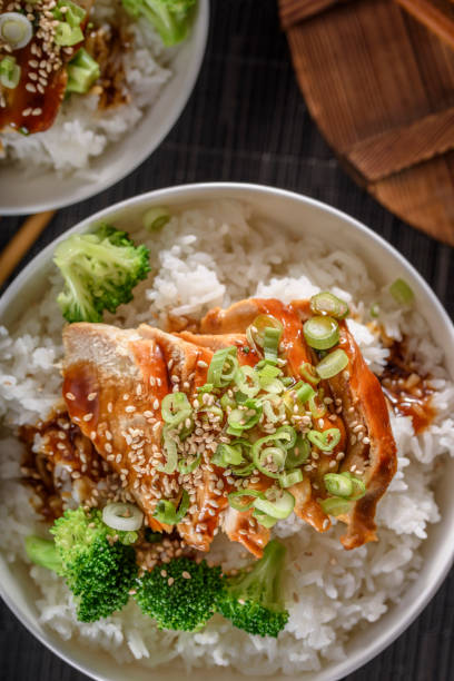 istock Grilled Chicken Breast with Teriyaki Sauce over Steamed Rice 697028286