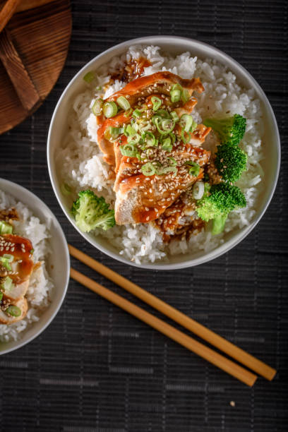 istock Grilled Chicken Breast with Teriyaki Sauce over Steamed Rice 697030334