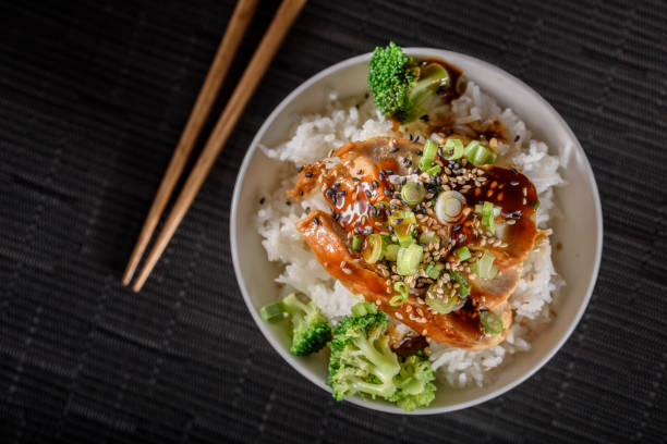 istock Grilled Chicken Breast with Teriyaki Sauce over Steamed Rice 697030336