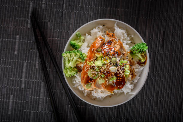 istock Grilled Chicken Breast with Teriyaki Sauce over Steamed Rice 697030374