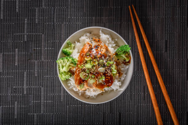 istock Grilled Chicken Breast with Teriyaki Sauce over Steamed Rice 697030442