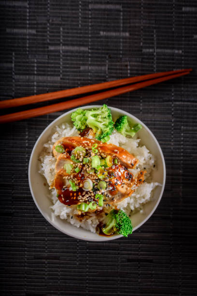 istock Grilled Chicken Breast with Teriyaki Sauce over Steamed Rice 697030448