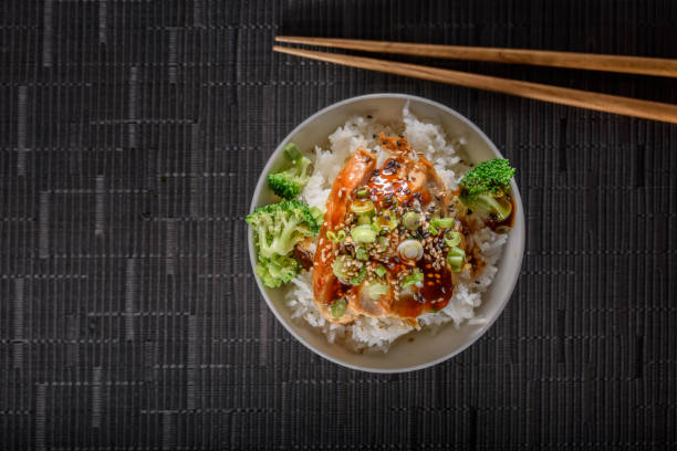 istock Grilled Chicken Breast with Teriyaki Sauce over Steamed Rice 697030482