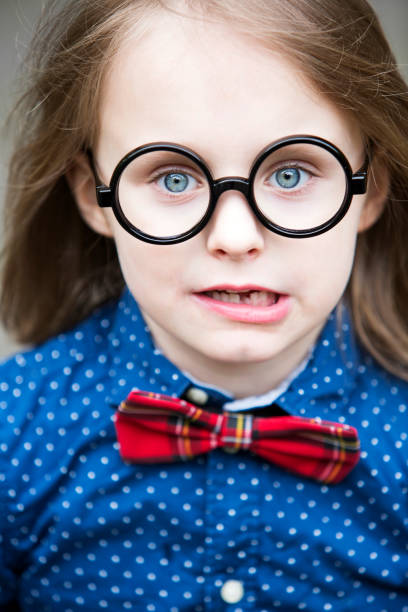 istock blond boy with bow tie and big glasses 697034302