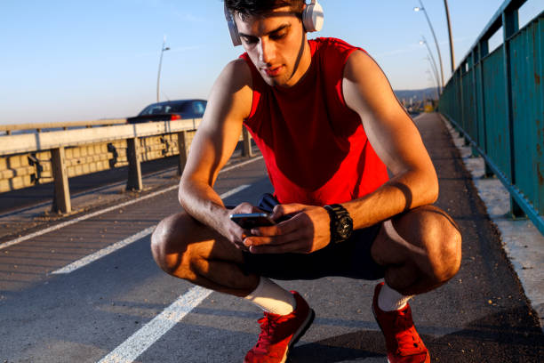 istock Portrait of young athlete man using mobile phone. 697037140