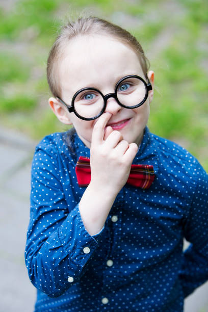 istock boy with big glasses is picking his nose 697037456