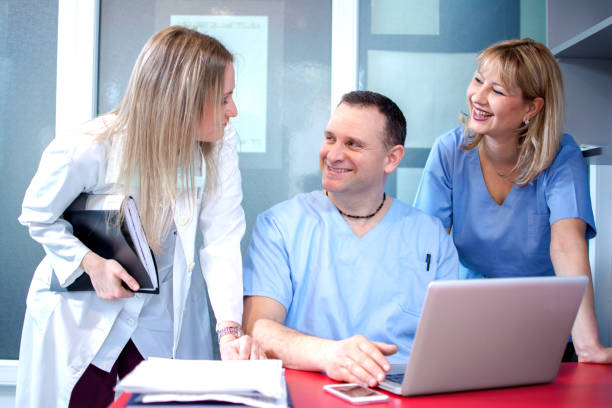 istock Small group of doctors working together in doctor's office. 697041376