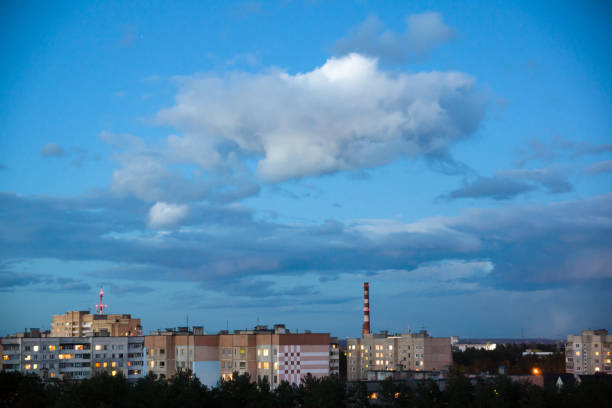 Clouds gather in the sky over the evening city