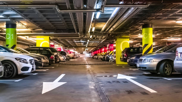 istock Modern, organized underground car parking garage, view from the floor 697051368