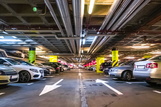 istock Underground car parking garage with surveillance cctv camera 697051404