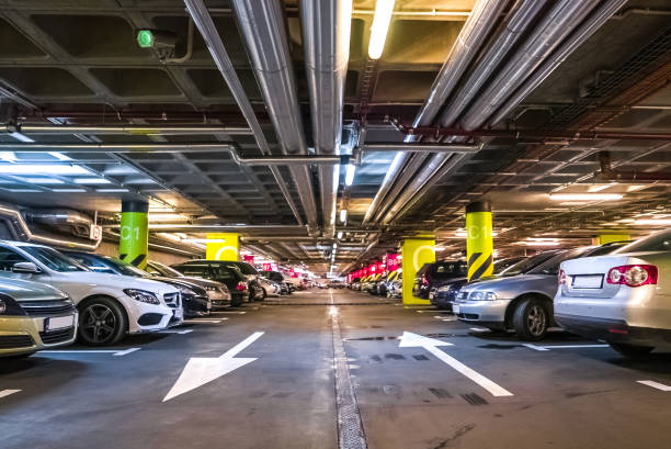 Underground car parking garage with surveillance cctv camera stock photo
