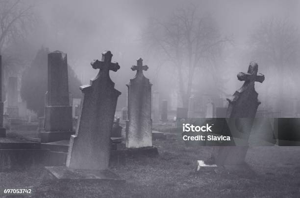 Old Creepy Haunted Cemetery On Foggy Night Stock Photo - Download Image Now - Cemetery, Spooky, Horror