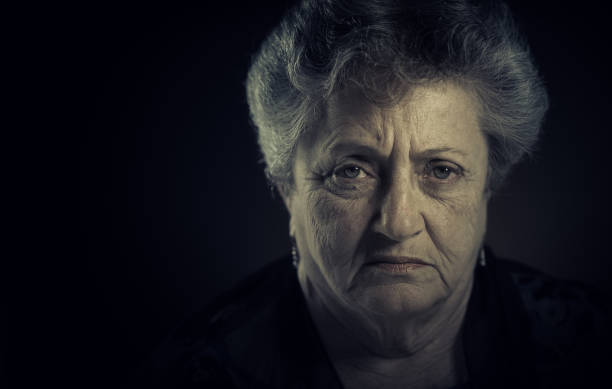 istock Senior lady low light portrait 697054094