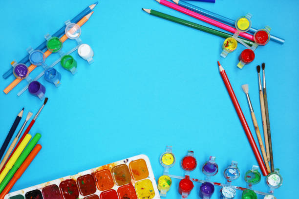 istock Watercolor Paints And Brushes on blue background 697054354