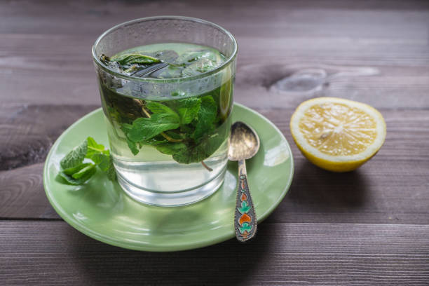 istock glass of tea with mint and a lemon on a dark table 697060398