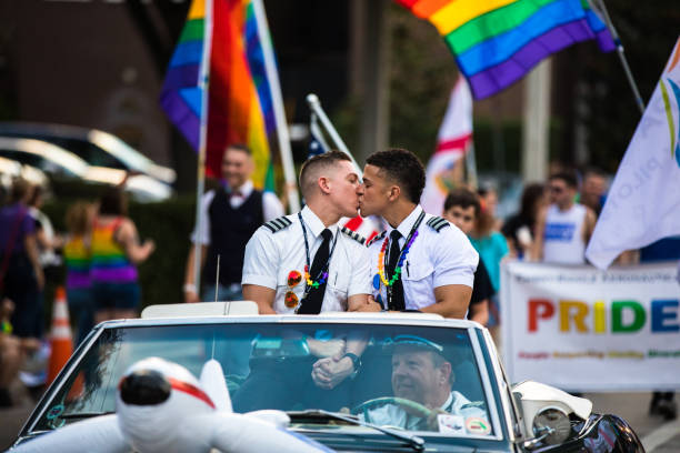 two man kissin at the  orlando pride  parade two mn kissing in the orlando pride parade pulse orlando night club & ultra lounge stock pictures, royalty-free photos & images