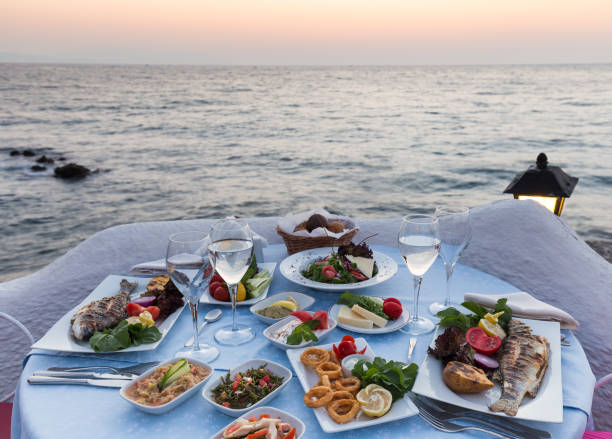 Dinner table ready for couple during sunset at seafood restaurant