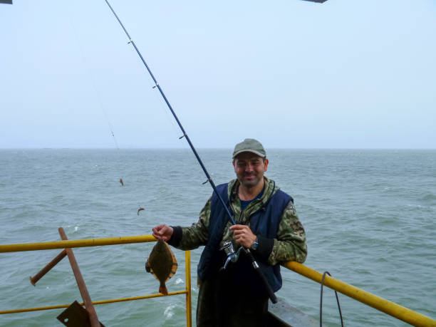 istock Flounder on the deck. Fishing on the boat. Bottom fish 697068024