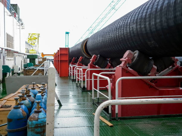 istock Moving the pipeline on rollers from the deck to the assembly workshop. Works on the installation of an underwater gas pipeline. 697068222