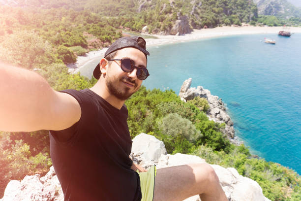 istock Young man  taking selfie in Olympos Antalya. 697091250