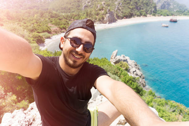istock Young man  taking selfie in Olympos Antalya. 697091252
