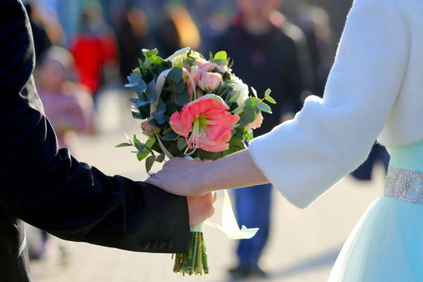 istock the bride and groom holding wedding bouquet 697096374