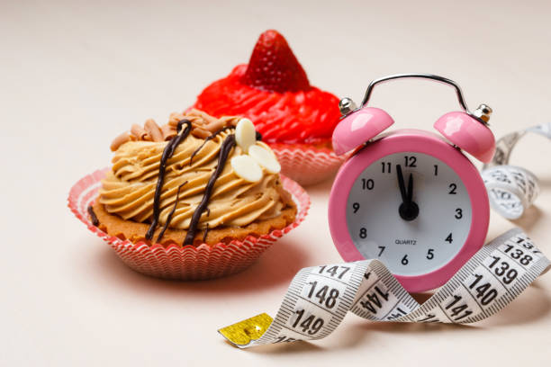 istock Sweet food measuring tape and clock on table 697119960